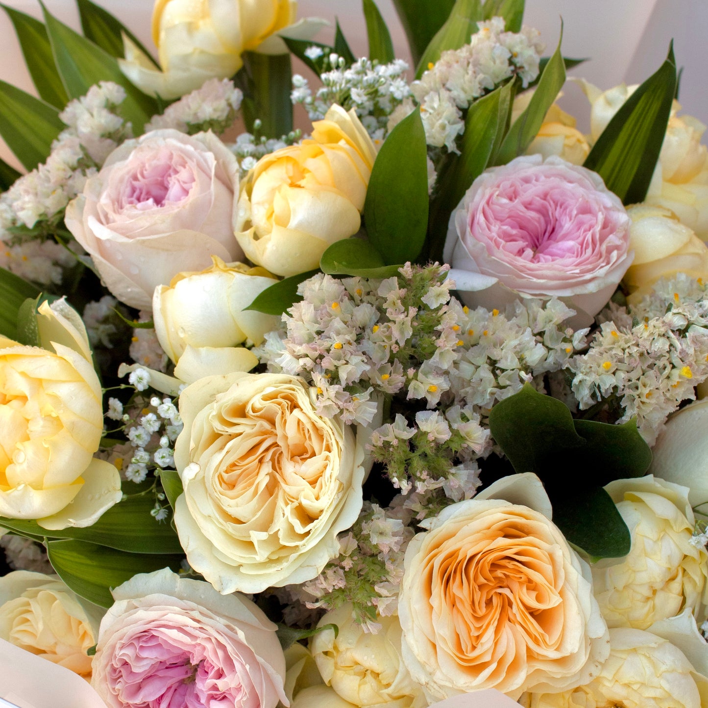 Vivid yellow blooms form the Butter Charm bouquet, beautifully placed in a minimal matte white Butter branded bag cheerful and sophisticated.