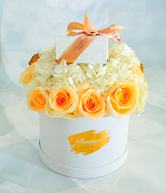 a luxury floral gift  filled with 24K gold-dusted and white roses, paired with Ladurée's Arabesque Box containing 8 gluten-free assorted macarons—an elegant and indulgent gift.