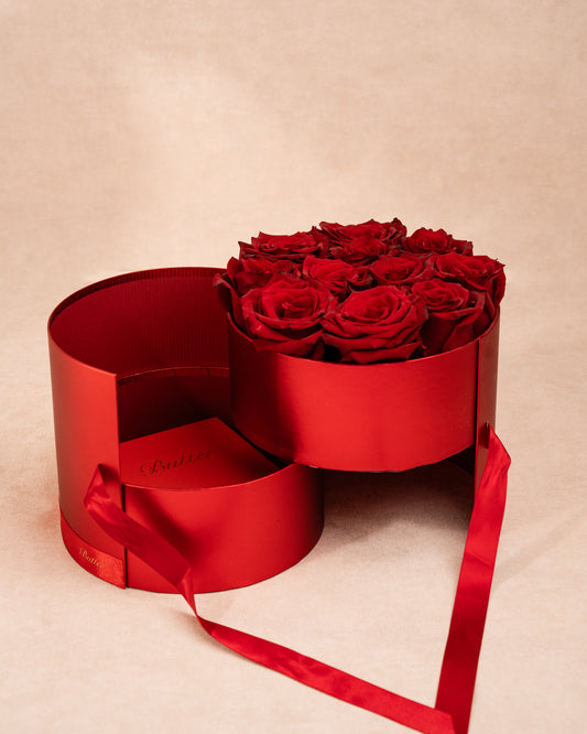 luxury gift box with roses and chocolate arranged in a cherry red box.