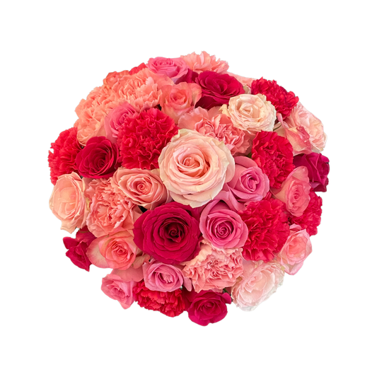 A circular white hatbox filled with a mix of pink roses and carnations.