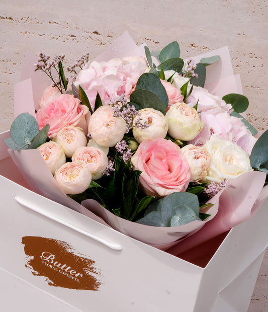 A closer view focusing on the delicate mix of baby peonies, hydrangeas, and garden roses presented in the BUTTER box.